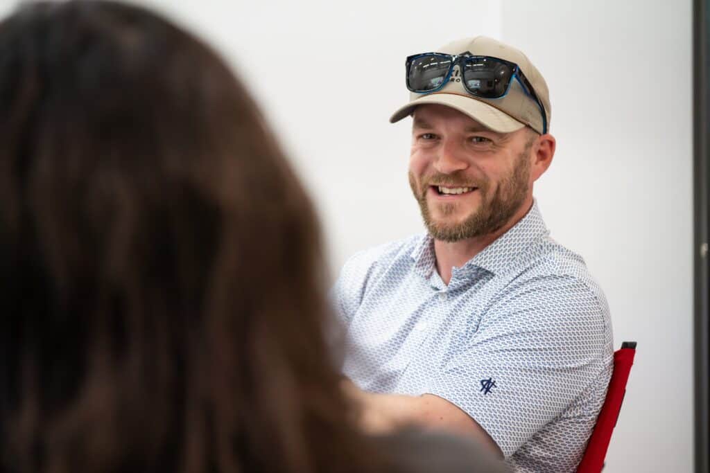 Construction professionals talking in office setting during mental health awareness initiative