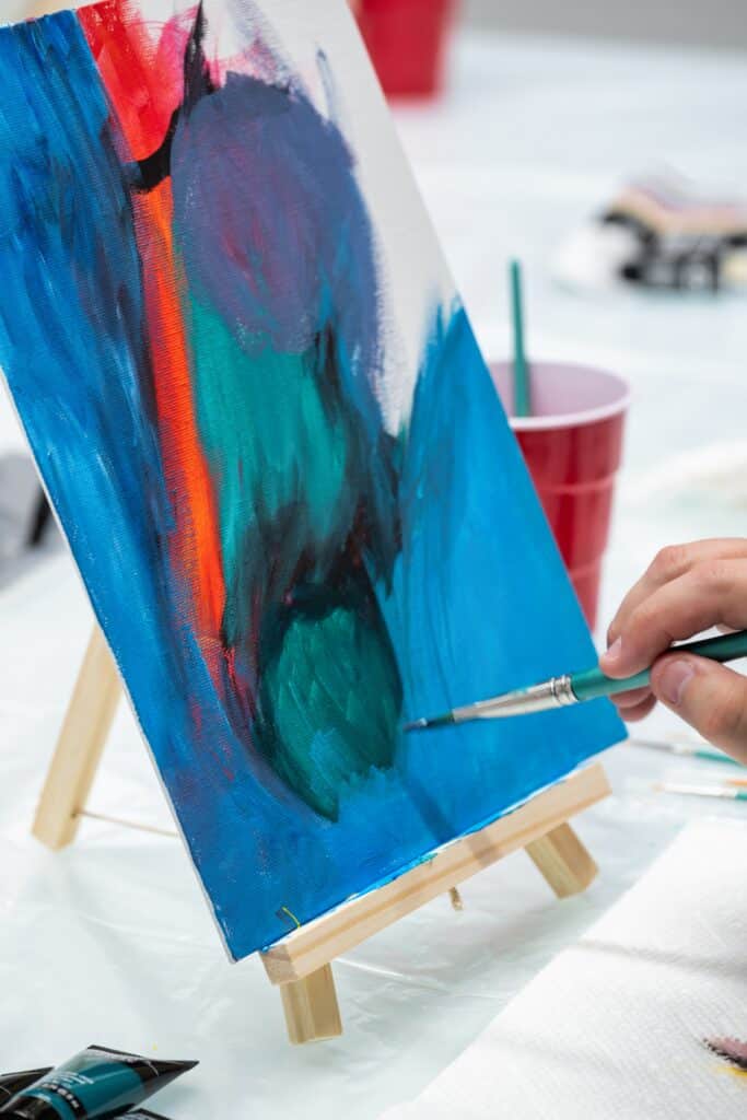 team painting activity mental health awareness workplace wellness