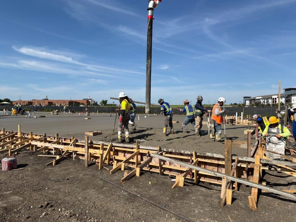 Concrete finishers complete the structural slab pour for the TMI Sports Medicine ASC after an overnight concrete placement in Grand Prairie, Texas.