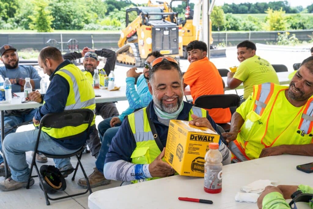 A construction trade partner receives a prize during the project appreciation event.